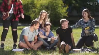 <strong>大学生</strong>在大学校园用平板电脑学习，坐在公园的草地上英俊的男<strong>大学生</strong>朋友